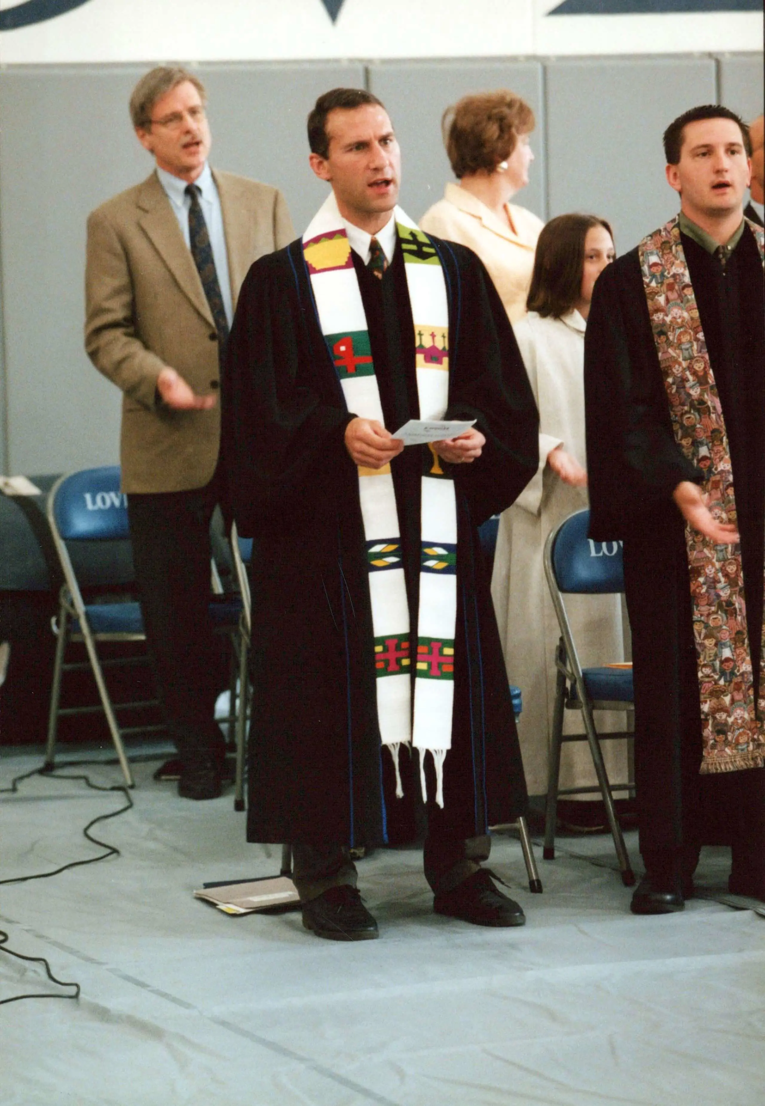 Reverend Steve Allen standing on a stage during a chapel service at The Lovett School.